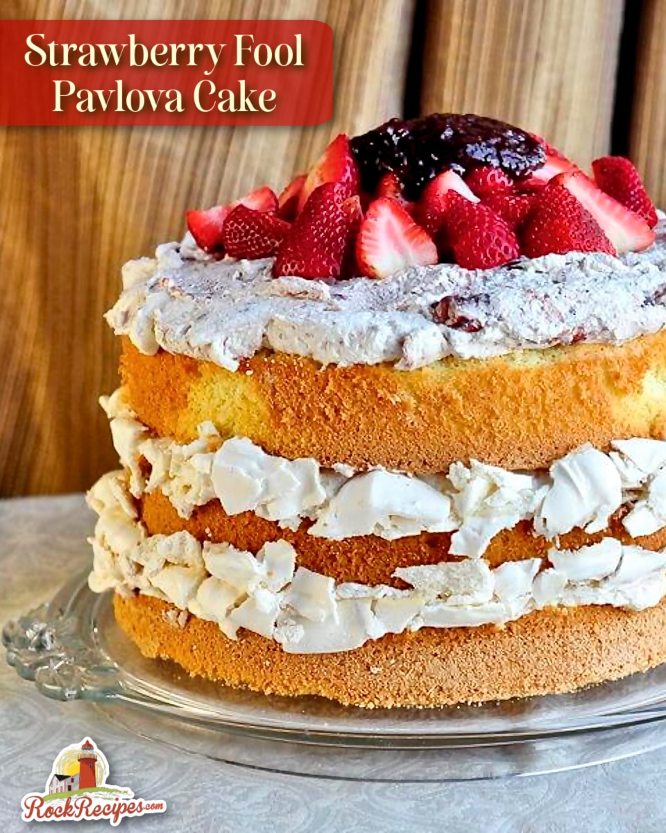 Strawberry Pavlova Cake. photo of uncut cake with title text and rock recipes logo added for Pinterest and social media posts.