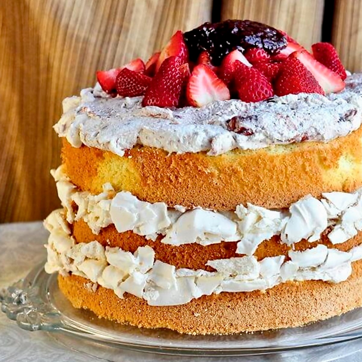 Strawberry Fool Pavlova Cake close up photo of uncut cake for featured post image