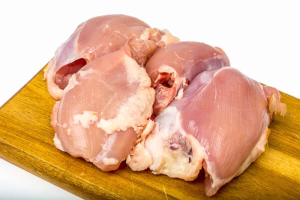 Raw chicken thigh meat. Stock Photo