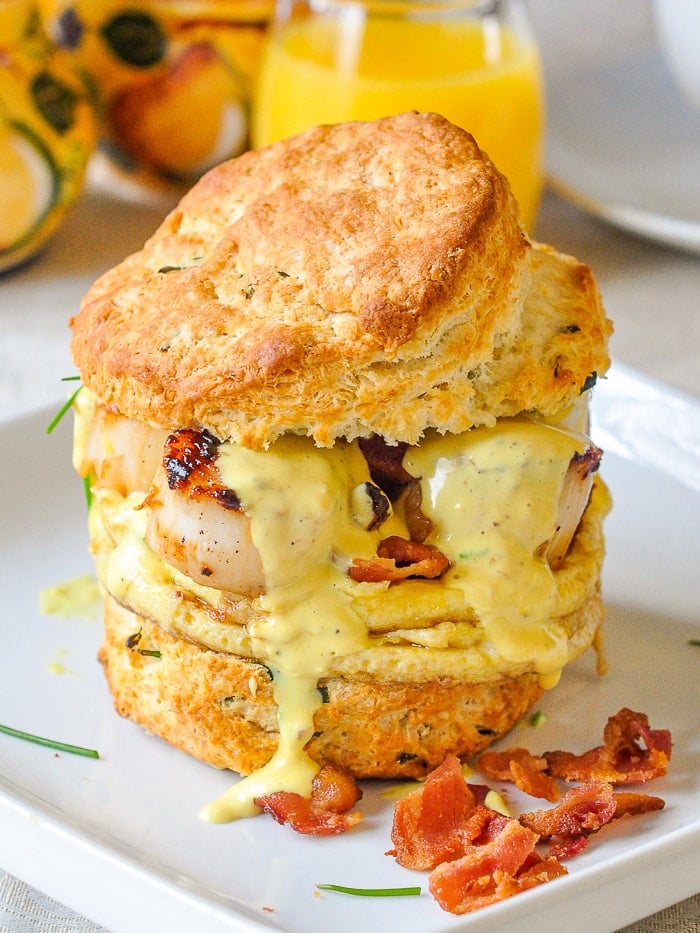 Scallops Benedict shown as a sandwich with the top jalf of the biscuit added on top