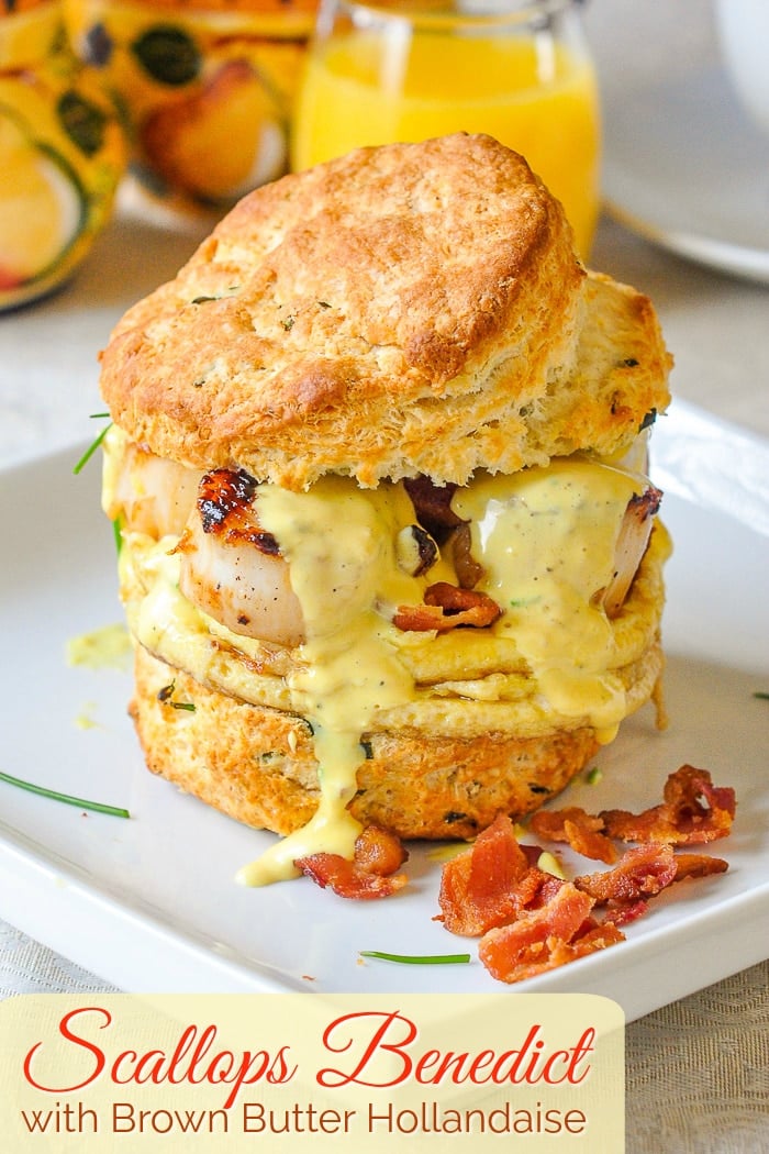 Scallops Benedict with crumbled bacon on a white plate with title text added for Pinterest