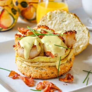 Scallops Benedict with egg and crumbled bacon on a buttermilk Biscuit