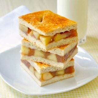 Apple Cobbler Bars stacked on a white plate.