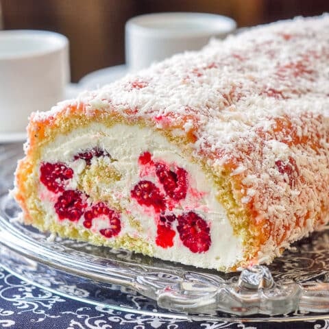 Billot Log Cake photo of completed cake on a clear glass serving plate