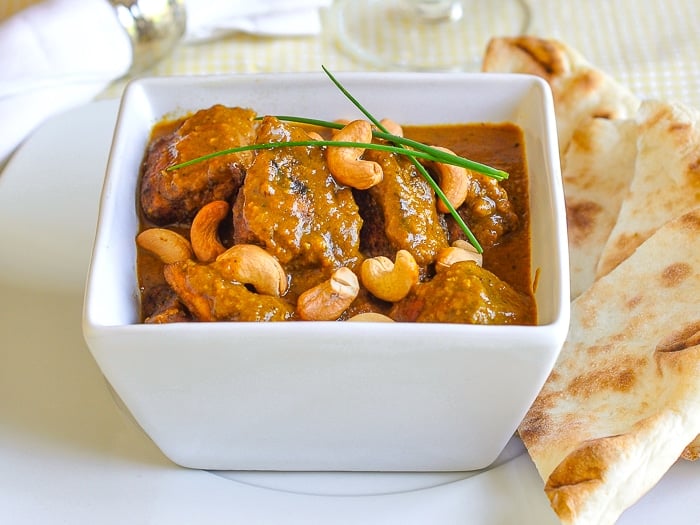 Easy Chicken Korma shown with naan on the side.