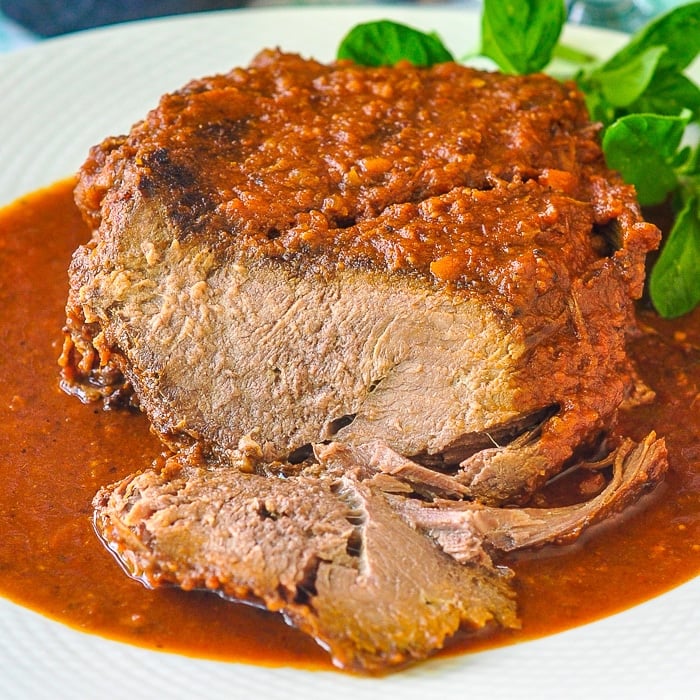 Pot Roast Bolognese close up photo of carved roast on a white platter