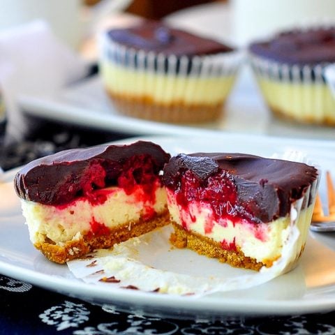 Raspberry Tuxedo Mini Cheesecakes close up photo of a cut serving revealing inside