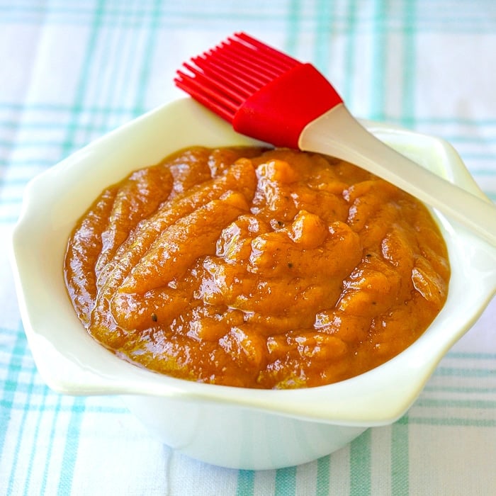 Roasted Pineapple Barbecue Sauce in a white dish with basting brush.