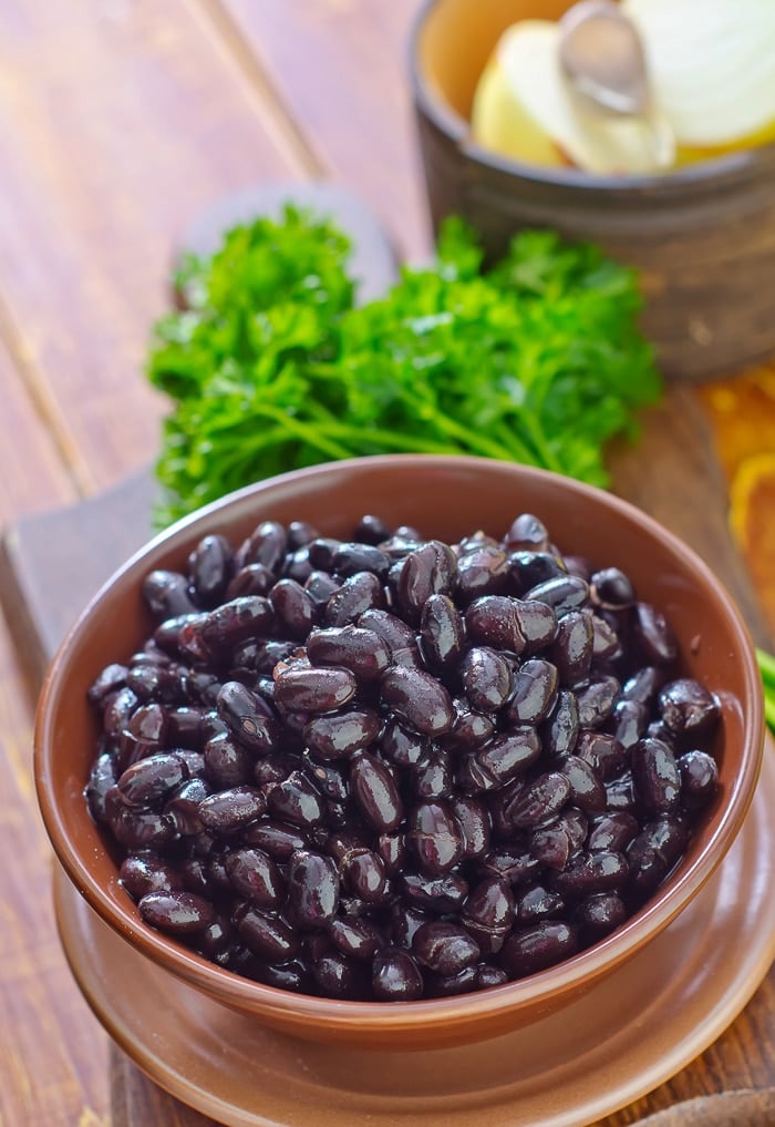 stock photo of black beans in a wooden bowl