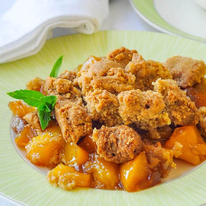 Mango Peach Coconut Crumble is an incredible combination of tropical and local flavours that combine to make one fantastic comfort food dessert. A scoop of good vanilla or coconut ice cream makes it even better.