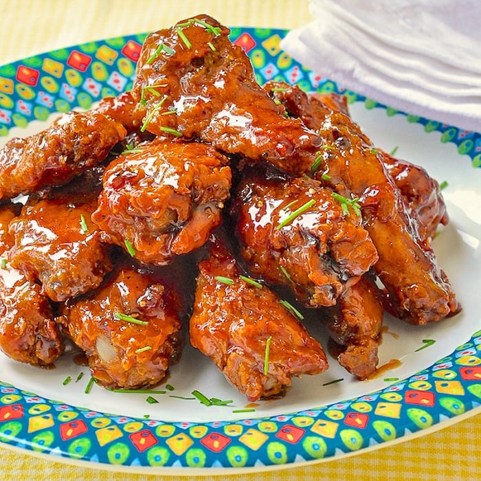 Crispy Baked Maple Sriracha Wings close up of wings on a multi coloured plate