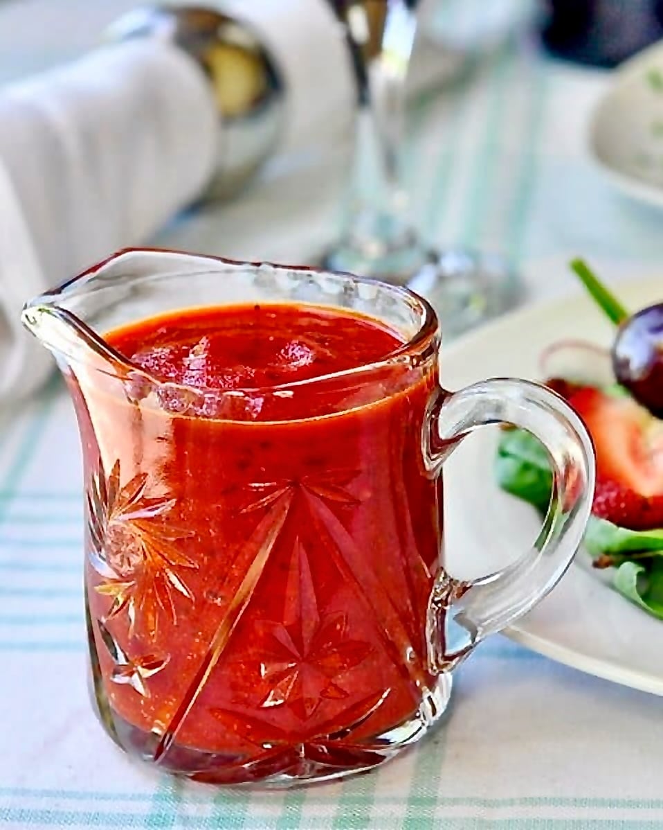 Roasted Red Pepper Salad Dressing. Photo of dressing in a crystal glass jug server.