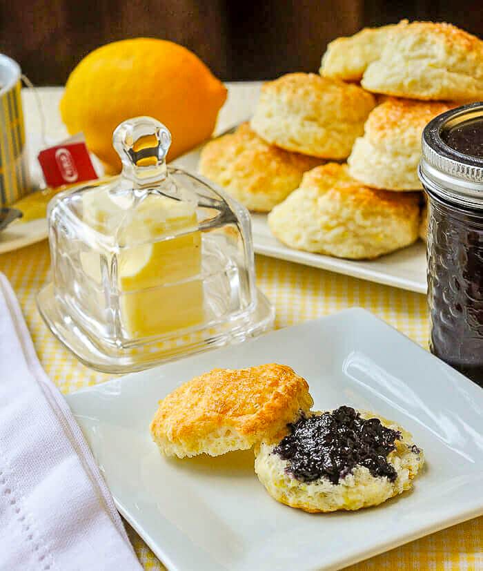 Sour Cream Lemon Scones set out for afternoon tea with blueberry jam and butter.