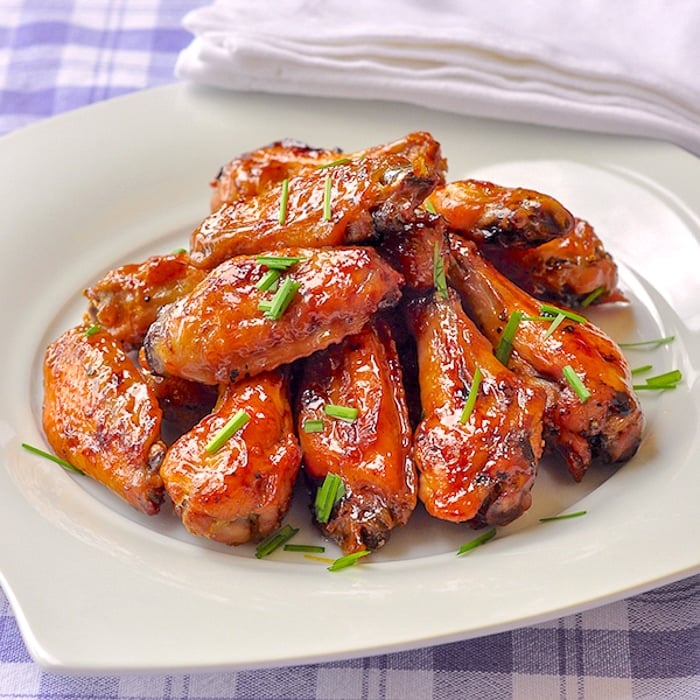 Brown Sugar Dijon Chicken Wings wide shot on white serving platter