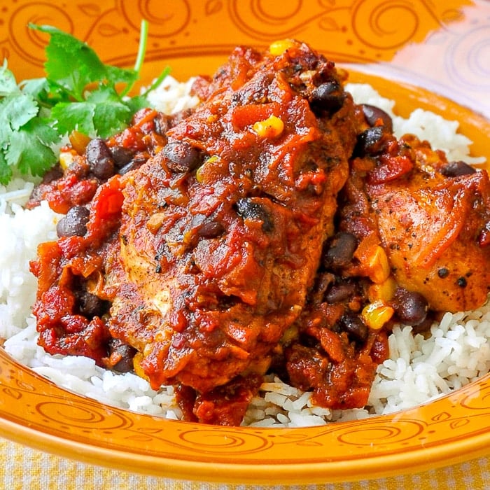 Chicken with Black Bean Chipotle Chili and Rice close up photo in an orange pattered bowl