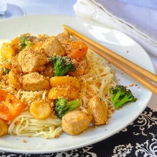 20 minute Honey Sriracha Chicken and Noodles close up photo of a single serving on a white plate