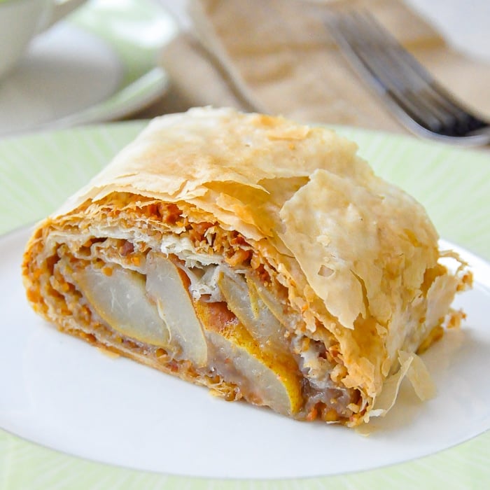 Pear Almond Baklava Roll close up of single serving on green edged plate