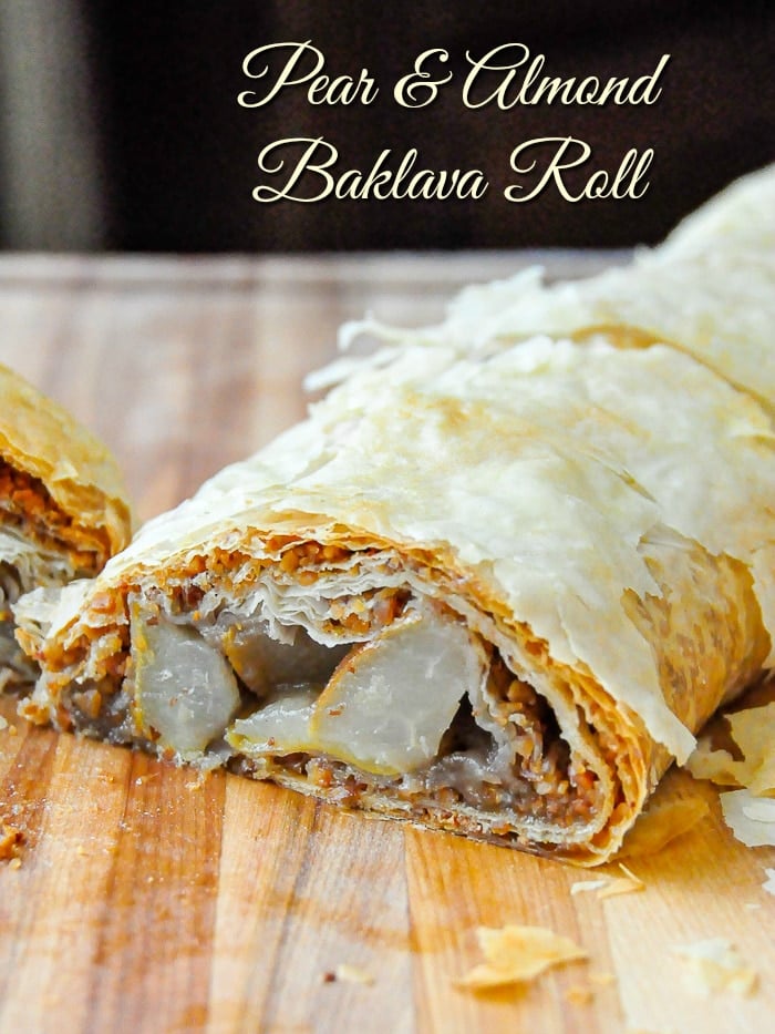 Pear Almond Baklava Roll photo of full roll on a wooden cutting board with title text added for Pinterest