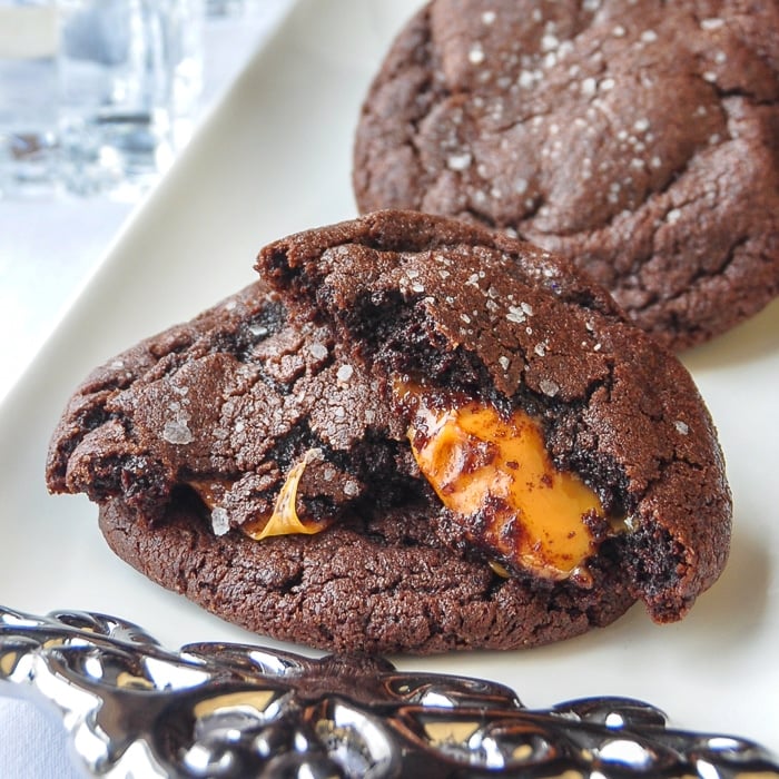 Caramel Stuffed Salted Chocolate Cookies photo of a cookie broken open to reveal the caramel centre