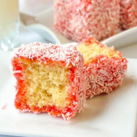 Close up photo of Strawberry Lamingtons cut in half to reveal centre