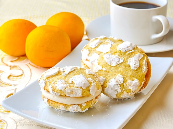 Lemon Cream Cheese Crackle Cookies shown with coffee in background
