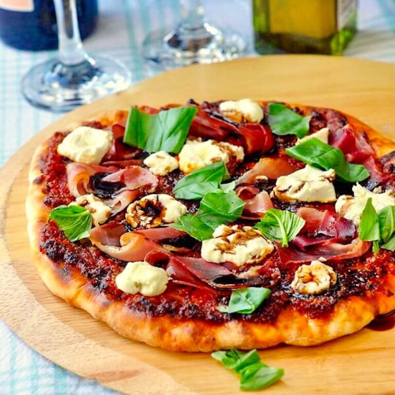Sundried Tomato Almond Pesto Pizza photo with photo of completed pizza on a wooden peel