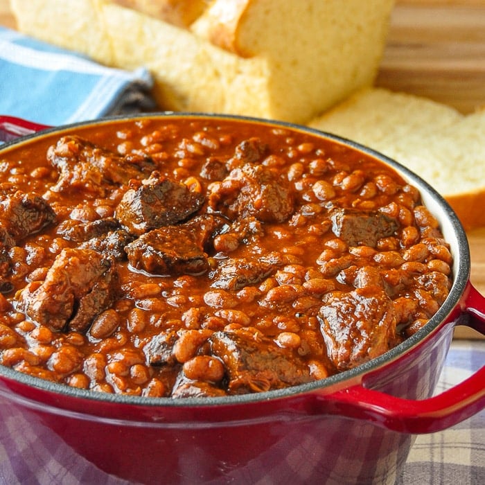 Maple Chipotle Pulled Pork and Beans. in a red enamelled cast iron dutch oven