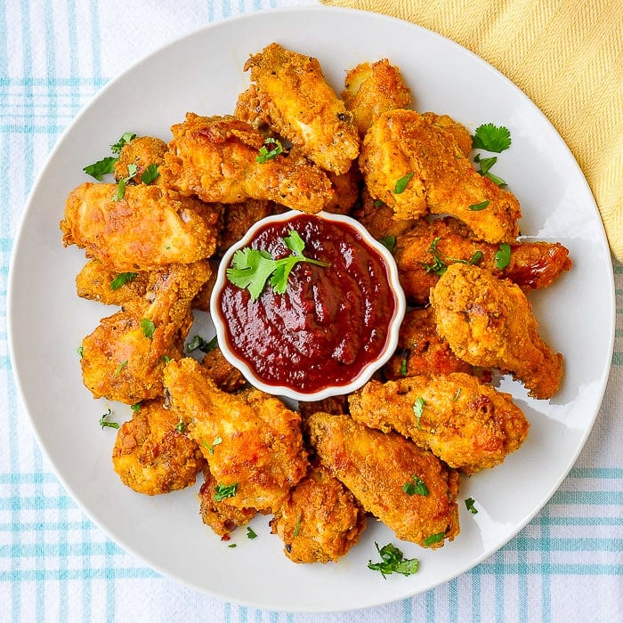 Oven Baked Wings with Honey Molasses Barbecue Sauce served on a white platter