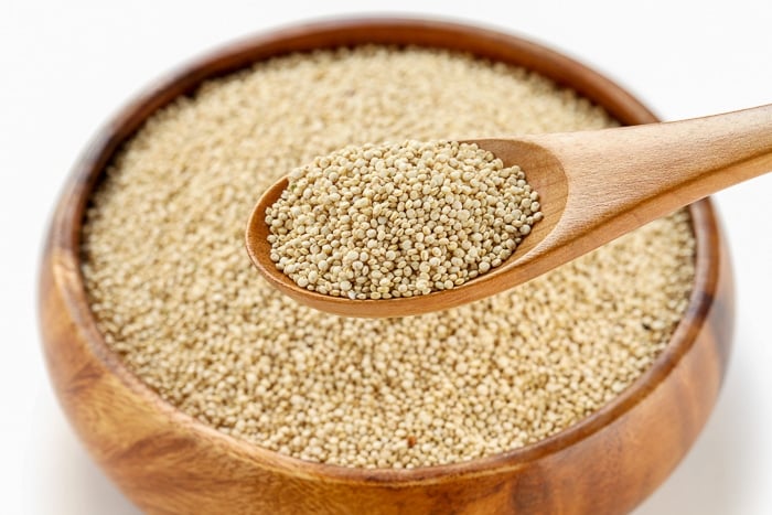 Close up of quinoa seeds on a wooden spoon