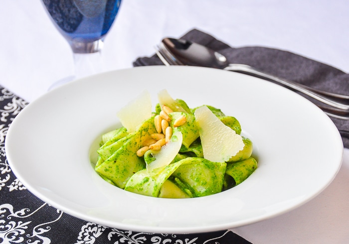 Wide shot photo of Spinach Pesto Pappardelle in a white bowl