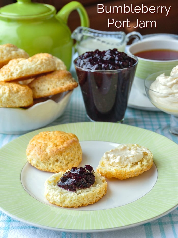 Bumbleberry Port Jam photo of jam with scones and cream with title text added for Pinterest