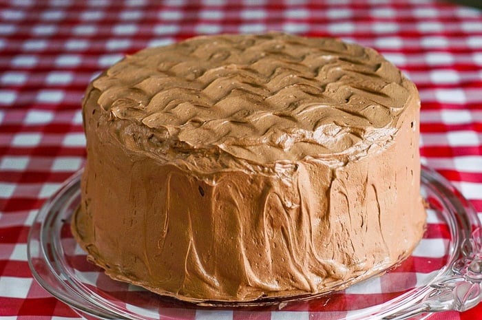 Chocolate Buttercream Frosting on a fully frosted uncut chocolate layer cake