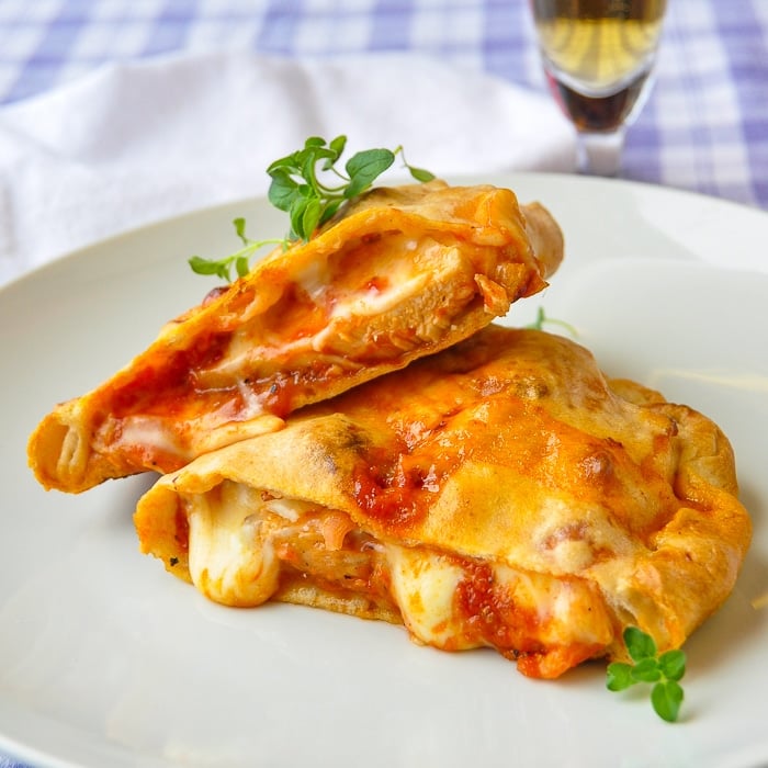 Close up of Crispy Thin Crust Barbecue Chicken Pizza made as calzones, cut in half to show filling.