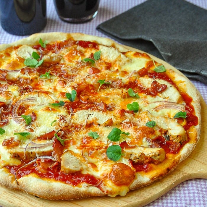 Crispy Thin Crust Barbecue Chicken Pizza on a wooden peel just out of the oven