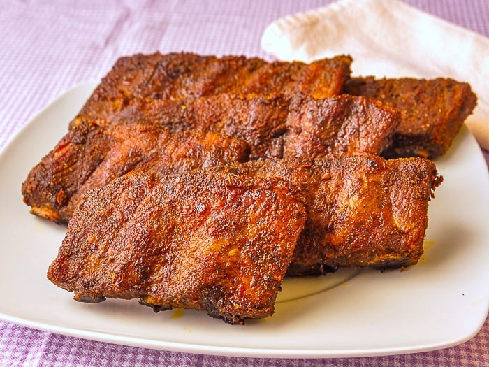 Uncut Dry Rubbed Oven Ribs on a white platter