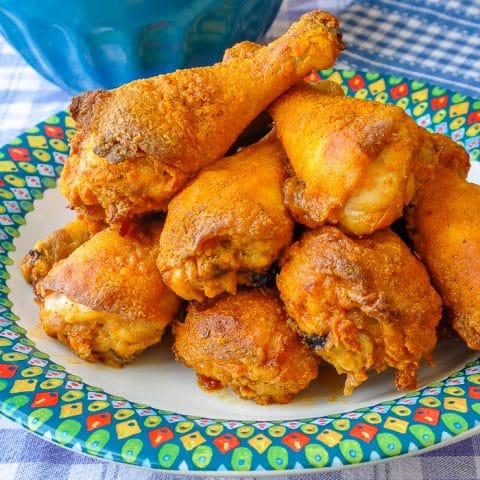 Barbecue Spice Oven Fried Chicken close up photo of cooked chicken pieces on a multicolored plate