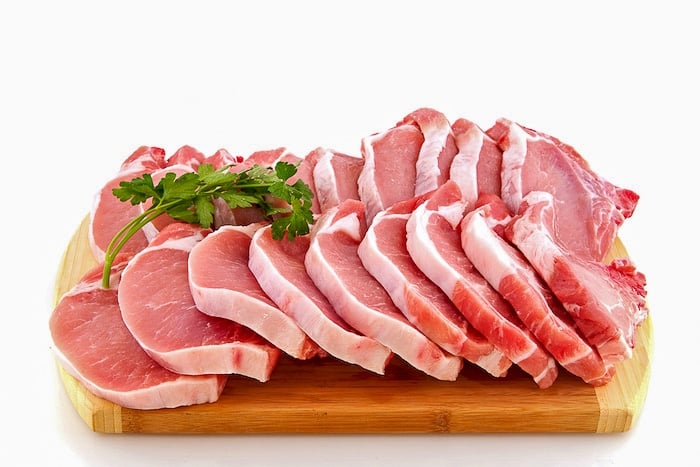 Many fresh pork chops or cutlets with parsley