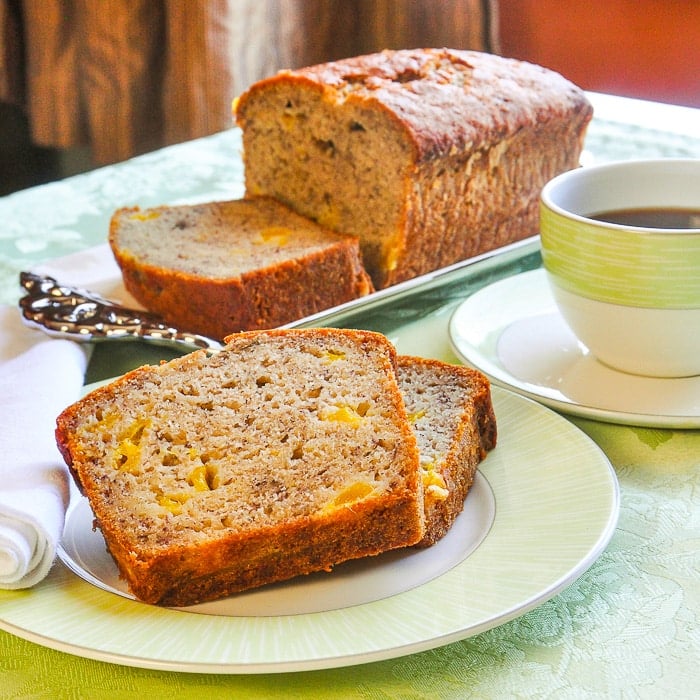 Photo of Mango Spice Banana Bread shown with a green coffee service
