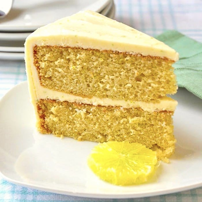 Lime Velvet Cake photo of a single slice on a white plate with slice of lime