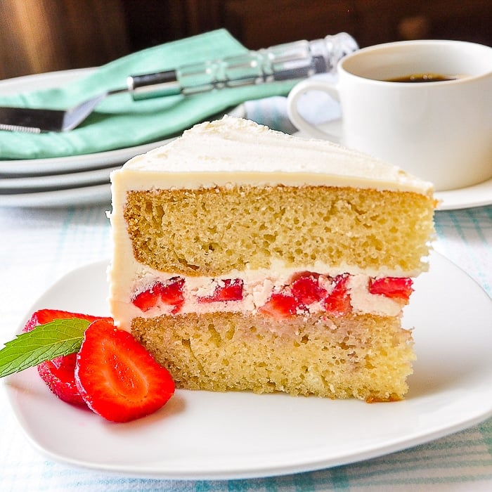 Strawberry Vanilla Butter Cake close up pohoto of a single slice on a white plate