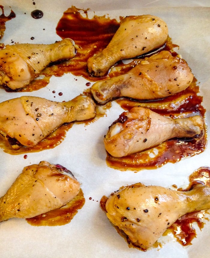 Glazed Sesame Chicken on a parchment paper lined baking sheet