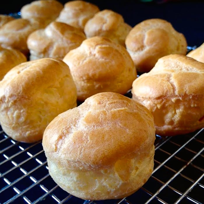 Choux pastries cooling on a wire rack