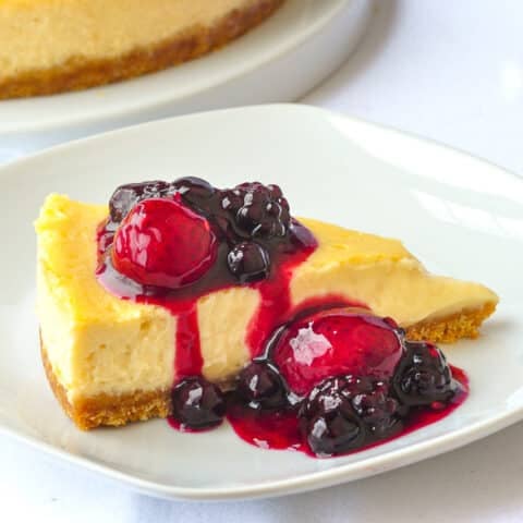 Close up photo of one slice of Bumbleberry Vanilla flan on a white plate