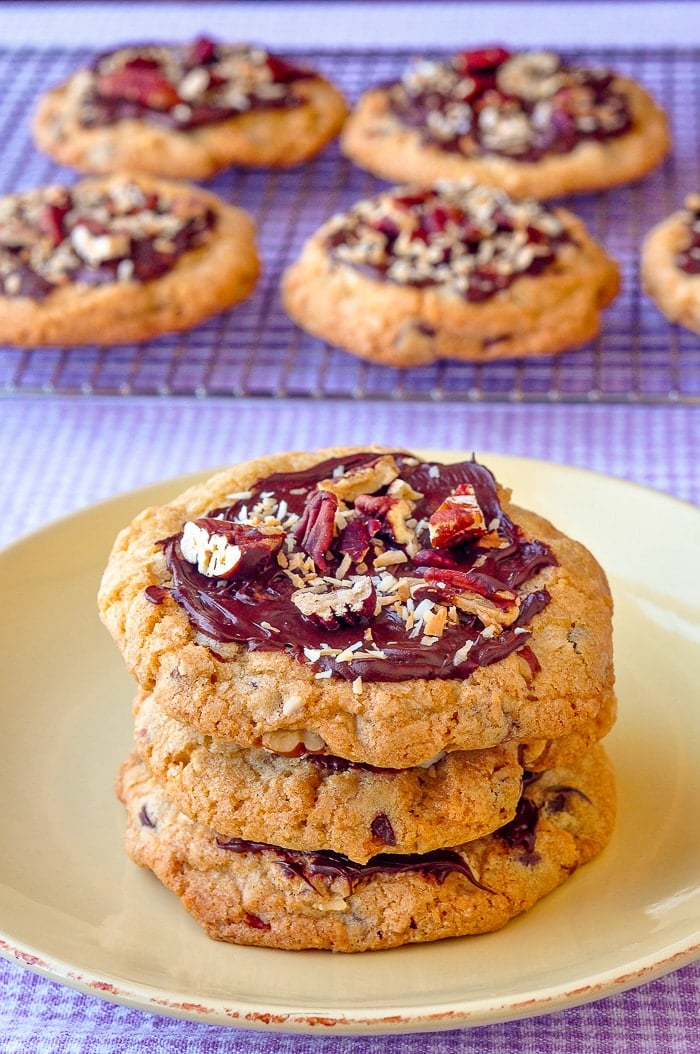 Coconut Pecan Chocolate Chip Cookies stacked on yellow plate