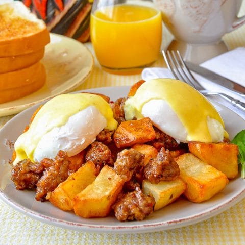 Italian Sausage Hash Eggs Benedict with Parmesan Hollandaise Sauce showing poached eggs intact