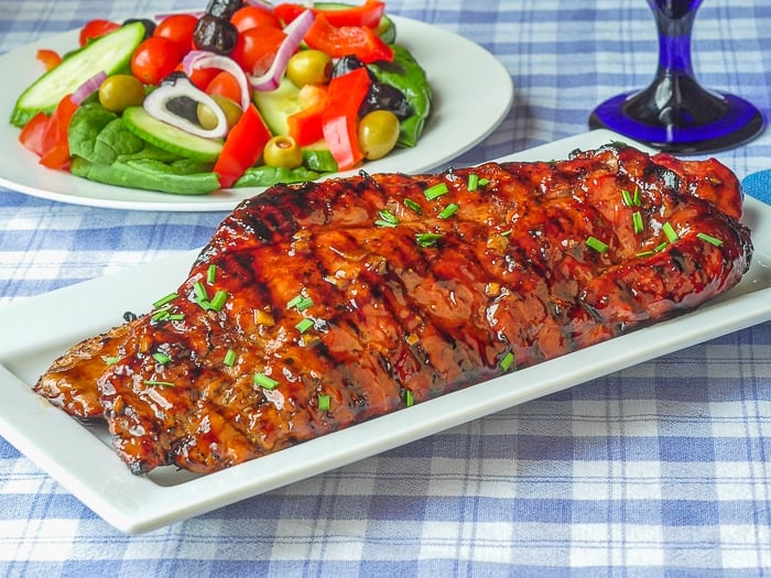 Low Fat Honey Garlic Boneless Ribs uncut slabs of ribs on white serving platter