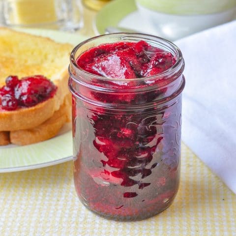 Strawberry Cranberry Jam close up photo of a bottle of jam at the breakfast table