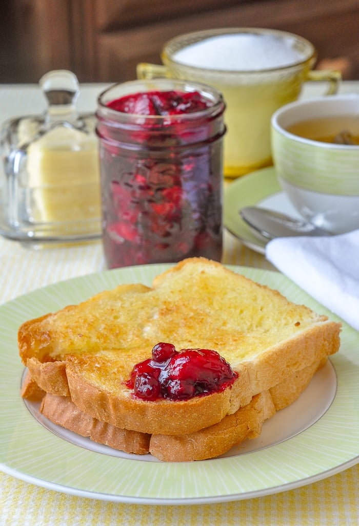 Strawberry Cranberry Jam shown on a piece of toast at the breakfast table