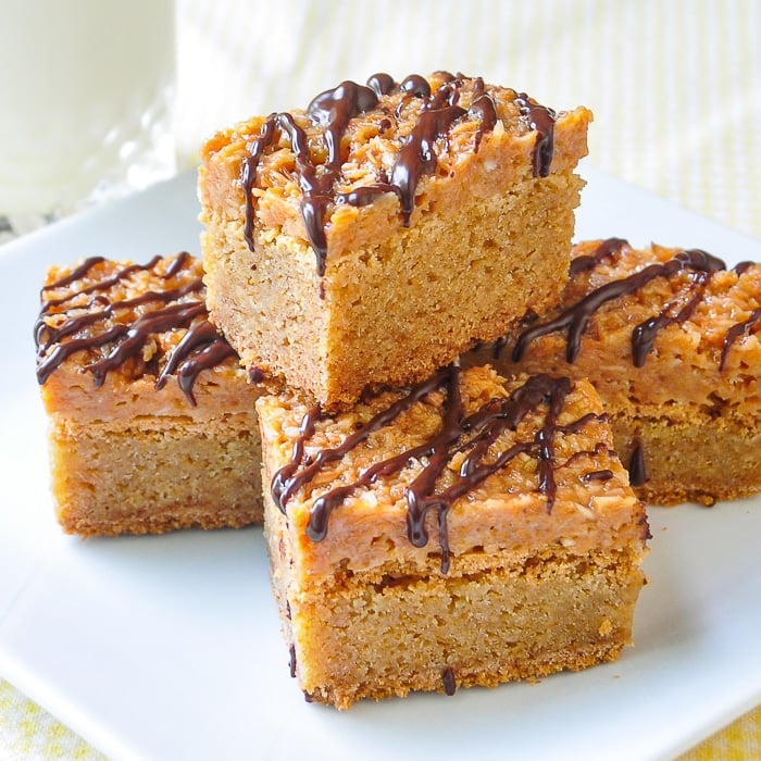 Photo of Samoa Blondies stacked on a square white plate
