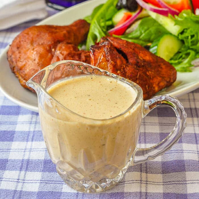 White Barbecue Sauce shown in a small pouring pitcher.